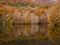 Wide shot of the beautiful Montseny mountain range surrounded by colorful trees in autumn in Spain