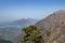 Wide shot of beautiful mountain ranges with two red peaks in the far away background. Geography Concept