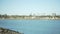 Wide shot of calm bay with oceanfront homes and palm trees