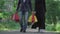 Wide shot of calm confident muslim couple walking to camera with shopping bags. Portrait of wealthy adult Middle Eastern