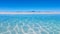 wide shot captures a breathtaking scene of great sand and blue water, epitomizing the essence of travel.