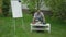 Wide shot of confident African American man in wheelchair turning pages of worksheet sitting in spring garden on