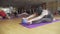 Wide shot of confident athletic people practicing yoga in gym. Sportsmen and sportswomen sitting on yoga mat and bending