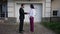 Wide shot confident man and woman shaking hands talking standing in front of house for sale. Caucasian seller and buyer