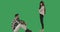 Wide shot of daughter and father arguing at chromakey background. Caucasian man sitting as teenage girl standing and