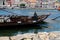 A wide shot of douro river with rabelo boat and a girl looking at horizon, Porto, Portugal