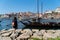 A wide shot of douro river with rabelo boat and a girl looking at horizon, Porto, Portugal