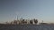 Wide shot of financial skyscrapers in downtown New York in Lower Manhattan filmed from the south river in late afternoon