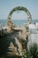 Wide shot of floral arch near the sea for a wedding ceremony during daytime