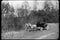 Wide shot of horse drawn carriage traveling through countryside