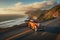 wide shot of hot rod cruising on a scenic coastal road