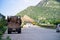 Wide shot of indian highway with trucks parked on side of road, cars, bikes, motorcycle and more on a wide asphalt road