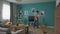 Wide shot of Man cleaning cozy apartment with vacuum cleaner