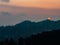 wide shot of mountain with city escape over the sunset in the background