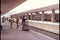 Wide shot of people waiting on train platform