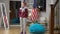 Wide shot portrait of angry frustrated woman standing in living room kicking bag chair thinking. Troubled Caucasian