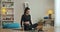 Wide shot portrait of beautiful young yogi sitting in lotus pose and doing breathing exercises using video lesson on