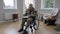 Wide shot portrait of concentrated paraplegic man in military uniform sitting on wheelchair writing letter. Focused