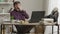 Wide shot portrait of overworked bored man with feet on table falling asleep during virtual conference. Tired middle