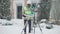 Wide shot portrait of professional concentrated African American man in hard hat using theodolite and checking project