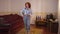 Wide shot portrait satisfied happy redhead woman posing in vintage bedroom indoors in slow motion. Positive confident