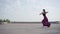 Wide shot of professional ballet dancer running and jumping up. Side view portrait of Caucasian ballerina practicing