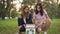 Wide shot proud teen eco-activists sitting at box with recycle sign looking inside. Happy confident Caucasian girls