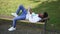 Wide shot relaxed confident African American student lying on bench outdoors learning material. Intelligent smart young