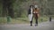 Wide shot of relaxed elegant senior and young women strolling in spring or autumn park chatting. portrait of carefree