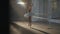Wide shot of slim graceful ballerina rehearsing spinning on tiptoes in dancing studio spotlight. Elegant charming