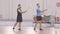 Wide shot of sportsmen training badminton hand movement indoors. Portrait of positive Caucasian men training sport game