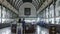 Wide shot stabilized pan and tilt from the ceiling to settle on a long interior perspective of the Saigon Central Post office