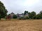 Wide shot of a stone house and some equipment on the field in Ratingen, Germany