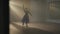 Wide shot of talented hard-working confident ballerina rehearsing dance in backlit fog in studio indoors. Slim gorgeous