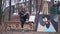 Wide shot talented young woman sitting on bench with picture drawing sketch with pencil. Happy smiling Caucasian