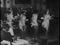 Wide shot of tap dancers performing in nightclub, 1930s