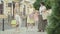 Wide shot of three women arguing on city street after shopping. Friends criticising buyings of beautiful Caucasian lady