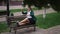 Wide shot tired exhausted obese Caucasian businesswoman sitting on bench putting legs up sighing. Portrait of adult plus