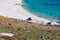 Wide shot of a tractor on the shore with a lot of rocks during daytime