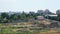 Wide shot of a vacant lot with the remains of a ruined building