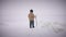 Wide shot winter landscape with indigenous senior man walking with stick in slow motion. Ice lying on frozen sea ocean