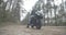 Wide shot of young biker in Covid face mask standing at black motorcycle and thinking. Portrait of thoughtful Middle