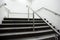 Wide staircase with chrome handrails