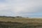 Wide steppe with yellow grass under a blue sky with white clouds Sayan mountains Siberia Russia