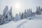 The wide trail leads to the snowy igloo. Winter mountain landscapes. Location place the Carpathian Mountains, Ukraine, Europe