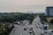 Wide urban freeway Asian metropolis. Modern buildings and structures. Singapore. Highway in dense rainforest