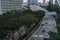 Wide urban freeway Asian metropolis. Modern buildings and structures. Singapore. Highway in dense rainforest