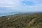 Wide view of bay on built up coast from mountain top