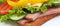 Wide view closeup sandwich with ham, lettuce, slices of cheese, tomatoes, cucumber