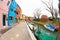 Wide view on colorful houses from a secondary street in Burano island during a cloudy winter day